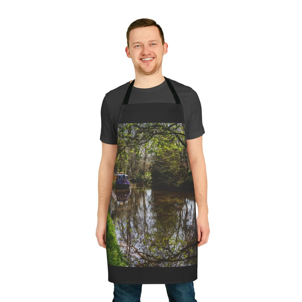 An apron featuring a peaceful canal barge and its reflections on the water.