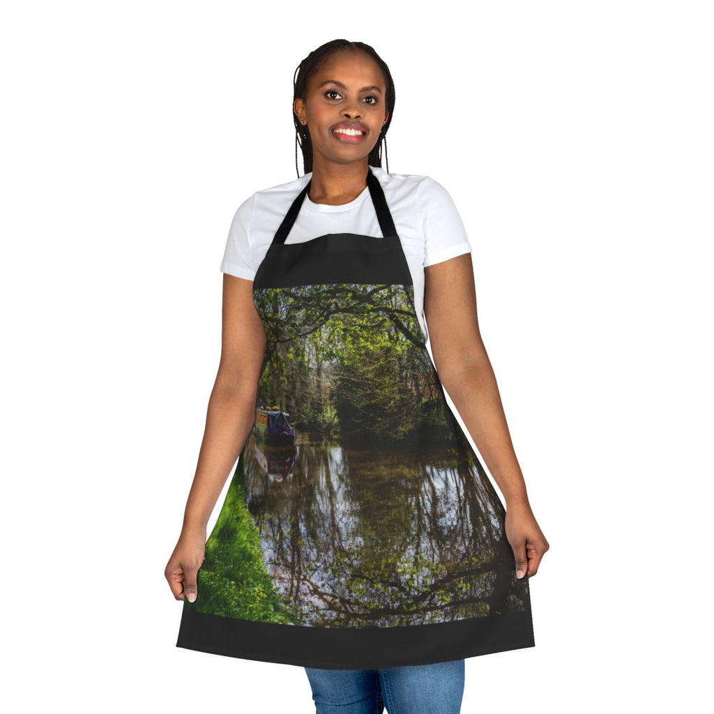 An apron featuring a peaceful canal barge and its reflections on the water.