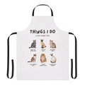 A white apron with a whimsical cat lady-themed graphic design.