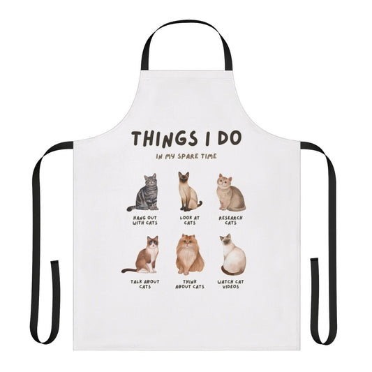 A white apron with a whimsical cat lady-themed graphic design.