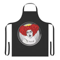 A woman wearing a Qveen Herby-inspired kitchen apron with the artist's name and album cover design.