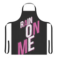 A pink apron with the phrase "Rain On Me" printed on it, inspired by the hit song from Lady Gaga's album Chromatica.