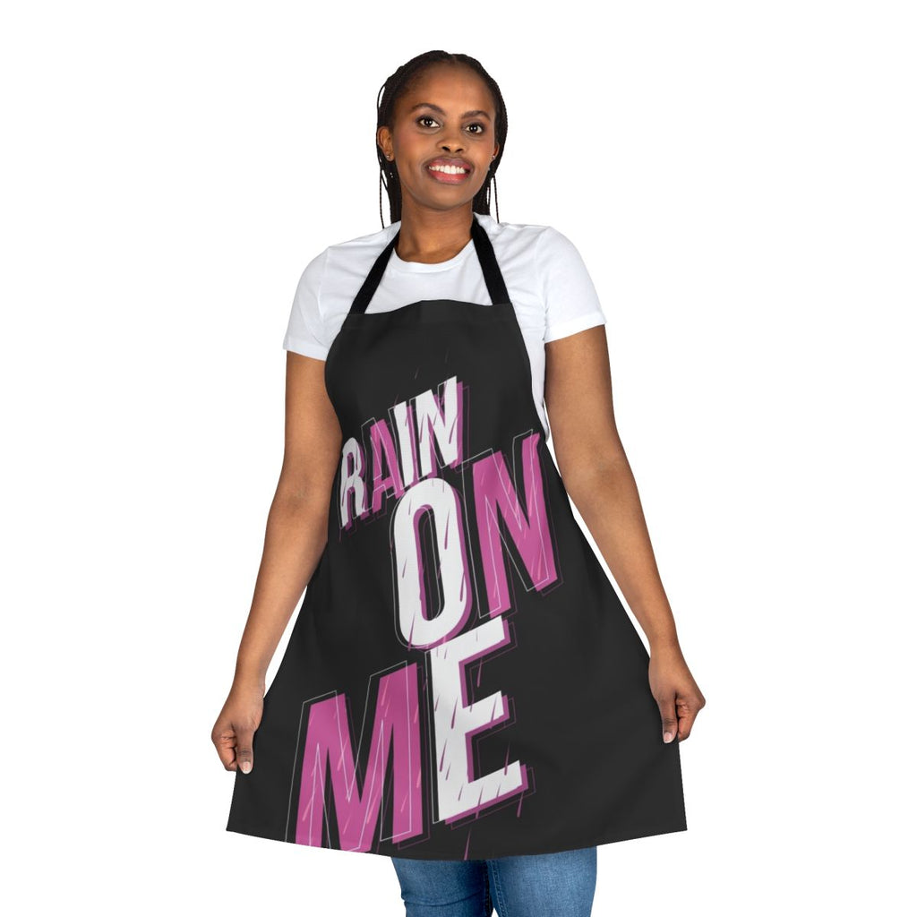 A pink apron with the phrase "Rain On Me" printed on it, inspired by the hit song from Lady Gaga's album Chromatica.