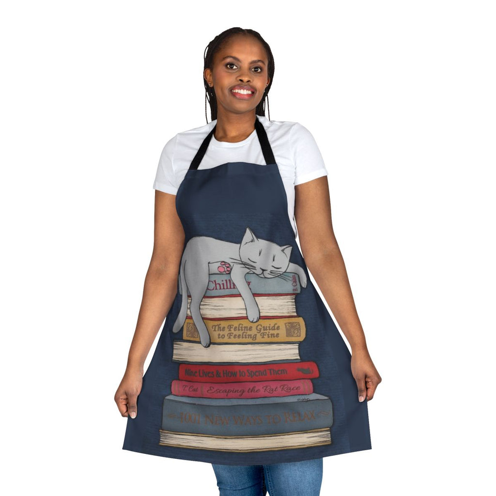 A grey apron with a cat sleeping design in blue and gold tones