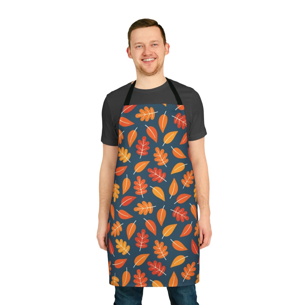 Retro-style apron featuring a pattern of autumn leaves in shades of orange, yellow, and blue on an indigo blue background.
