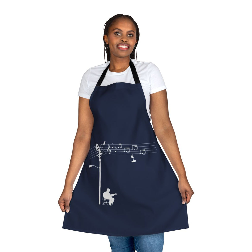 A white apron with a retro, funky design featuring musical elements like wires, sheet music, and a treble clef.
