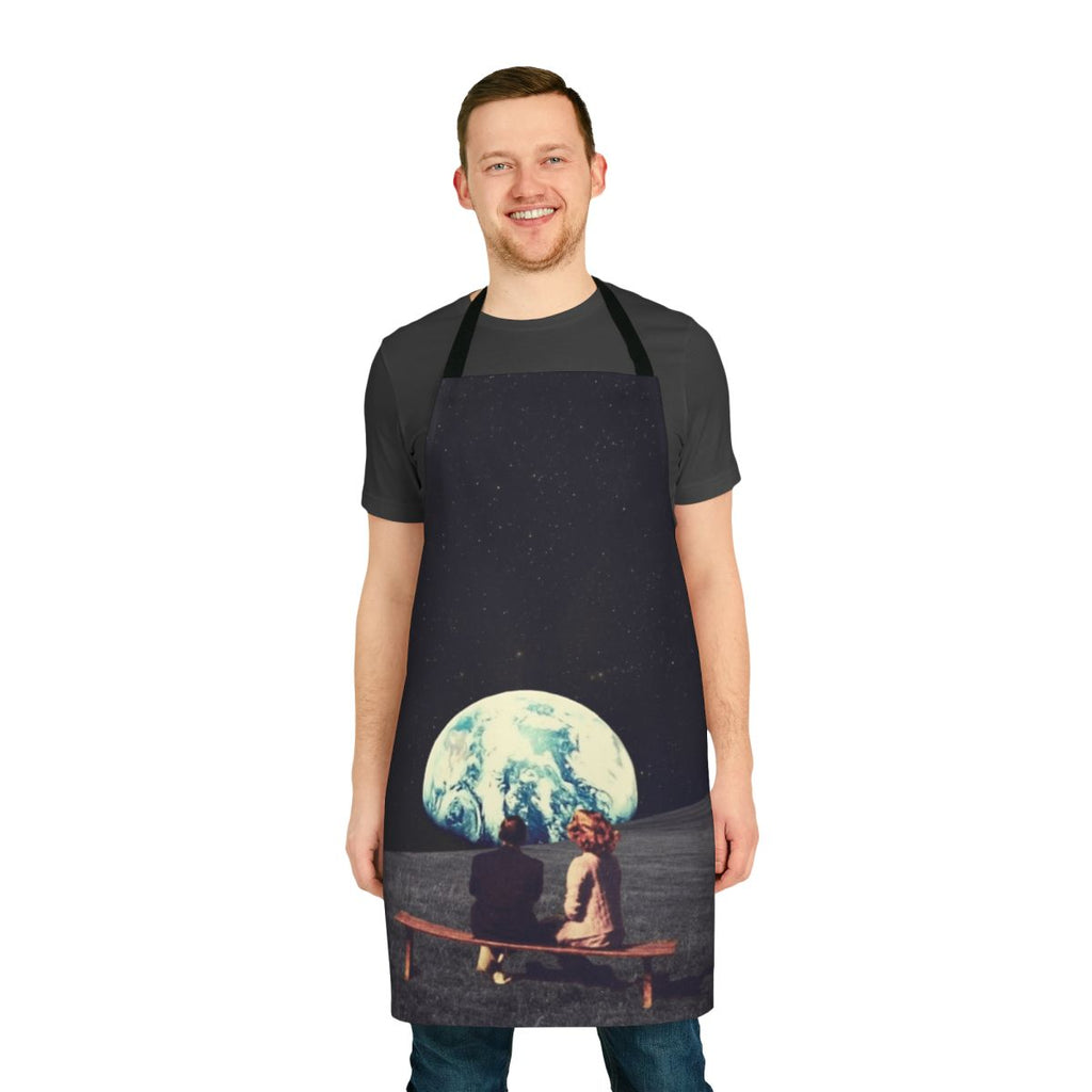 A surreal, vintage-inspired apron featuring a collage of a couple waiting against a backdrop of a space landscape with stars, planets, and satellites.