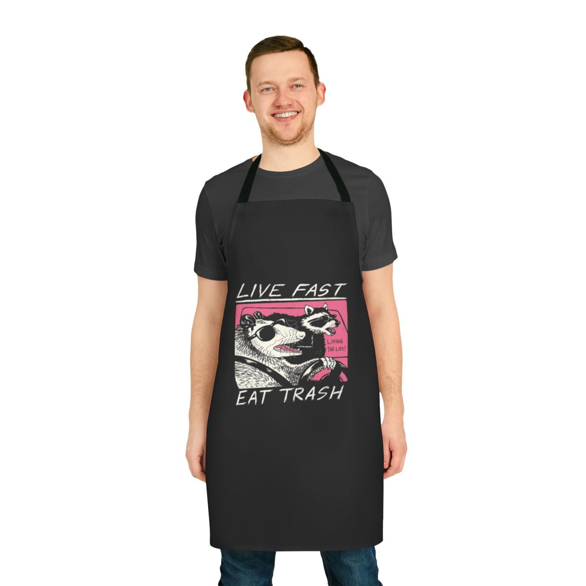 Retro-style apron with "Live Fast Eat Trash" design, featuring a raccoon graphic and 80s inspired elements