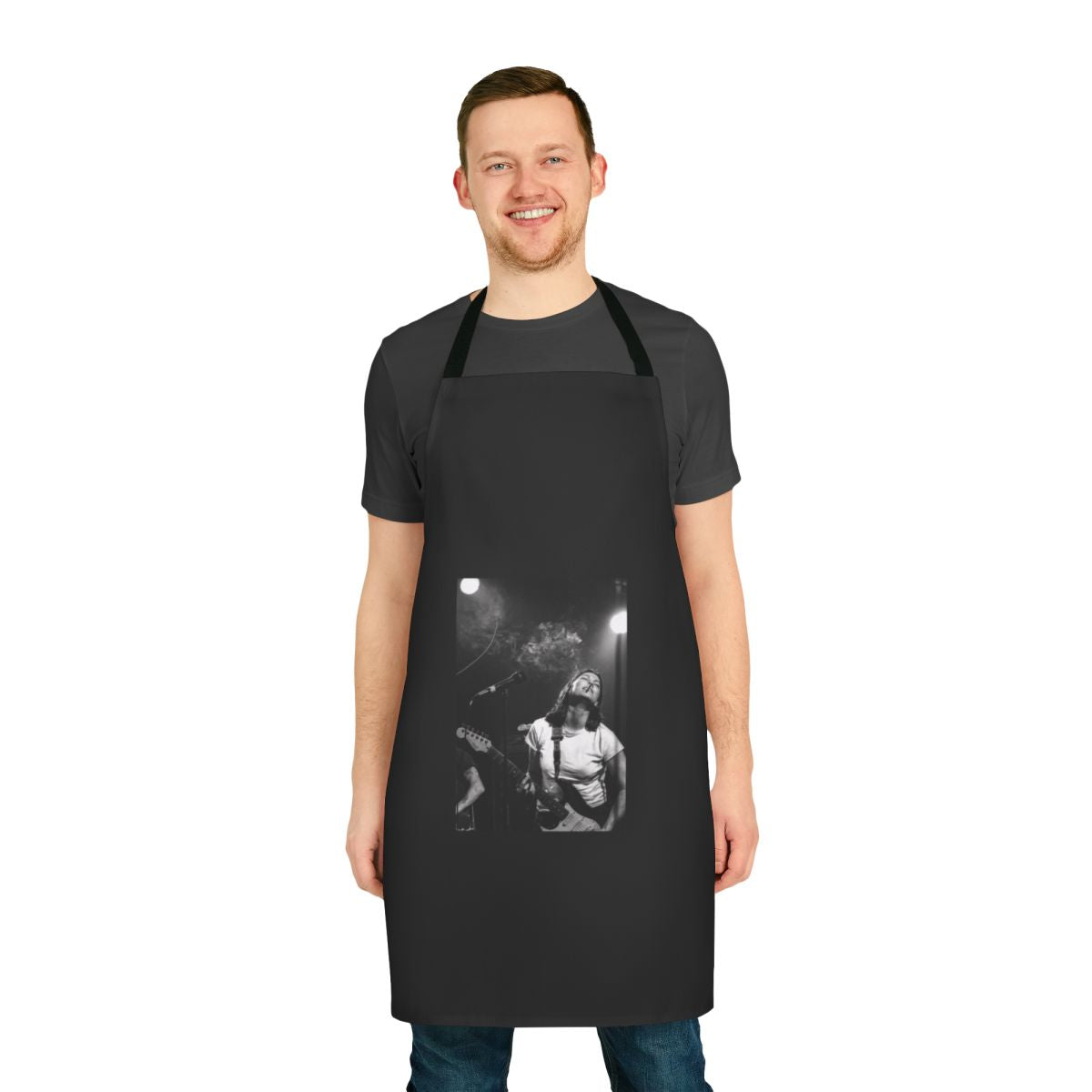 Black and white portrait of Kim Deal of The Breeders playing guitar, printed on a high-quality apron.