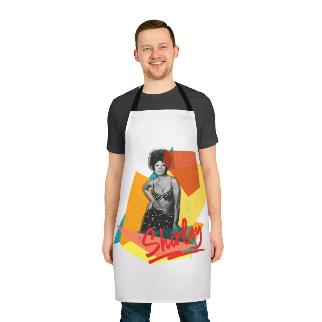 Colorful vintage-style apron featuring Shirley Bassey's name and music imagery