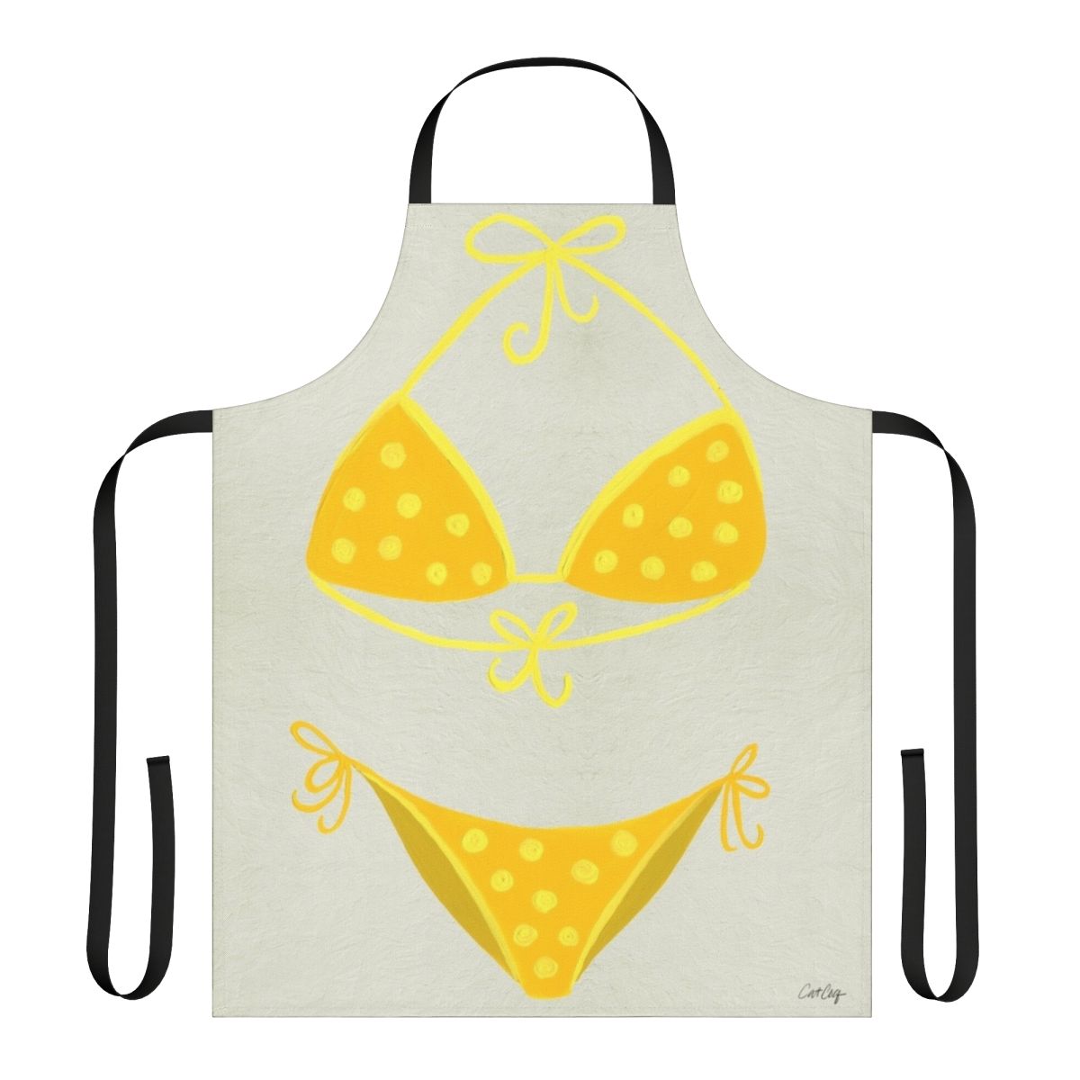 A cream-colored apron with a yellow polka dot pattern, inspired by classic swimsuit styles.