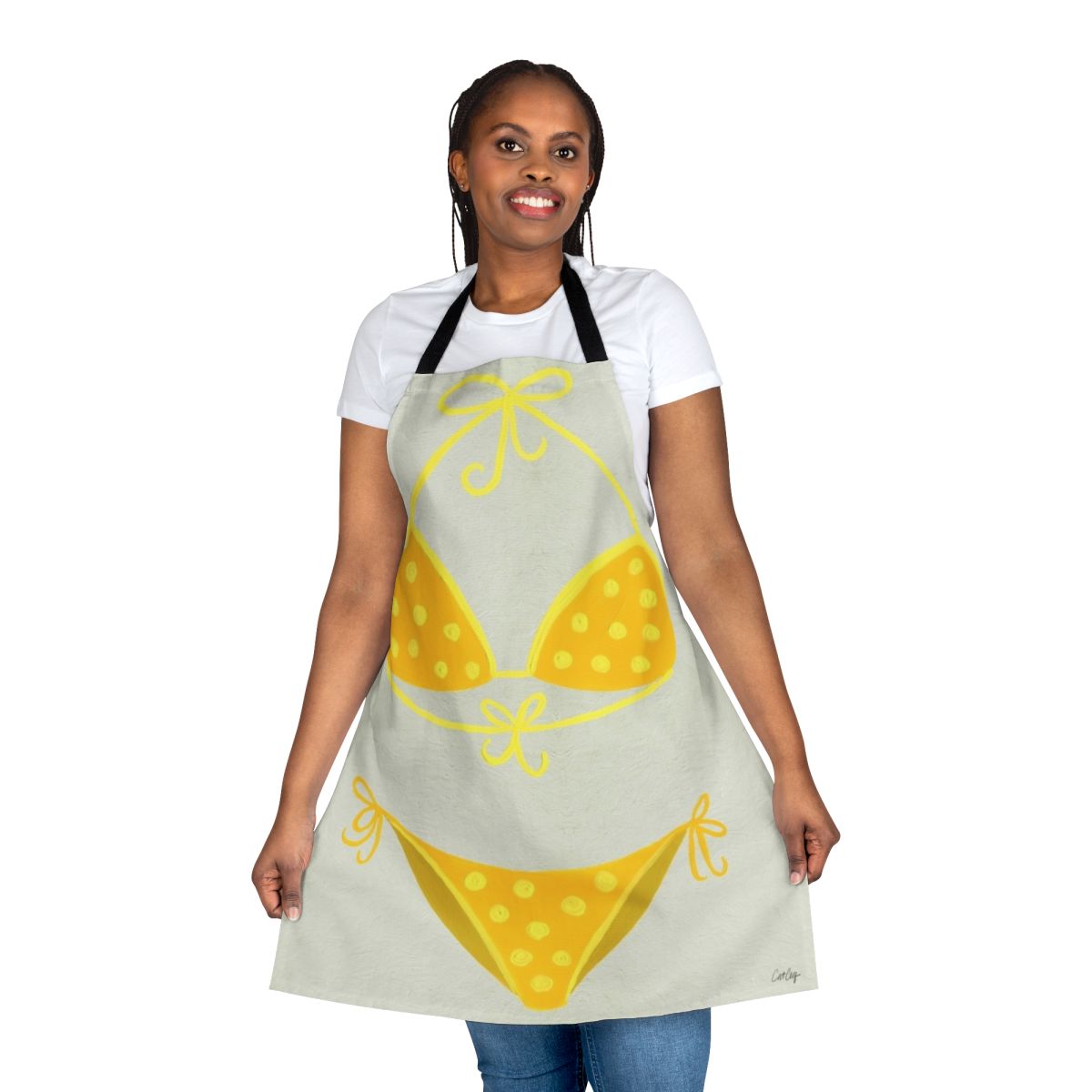 A cream-colored apron with a yellow polka dot pattern, inspired by classic swimsuit styles.