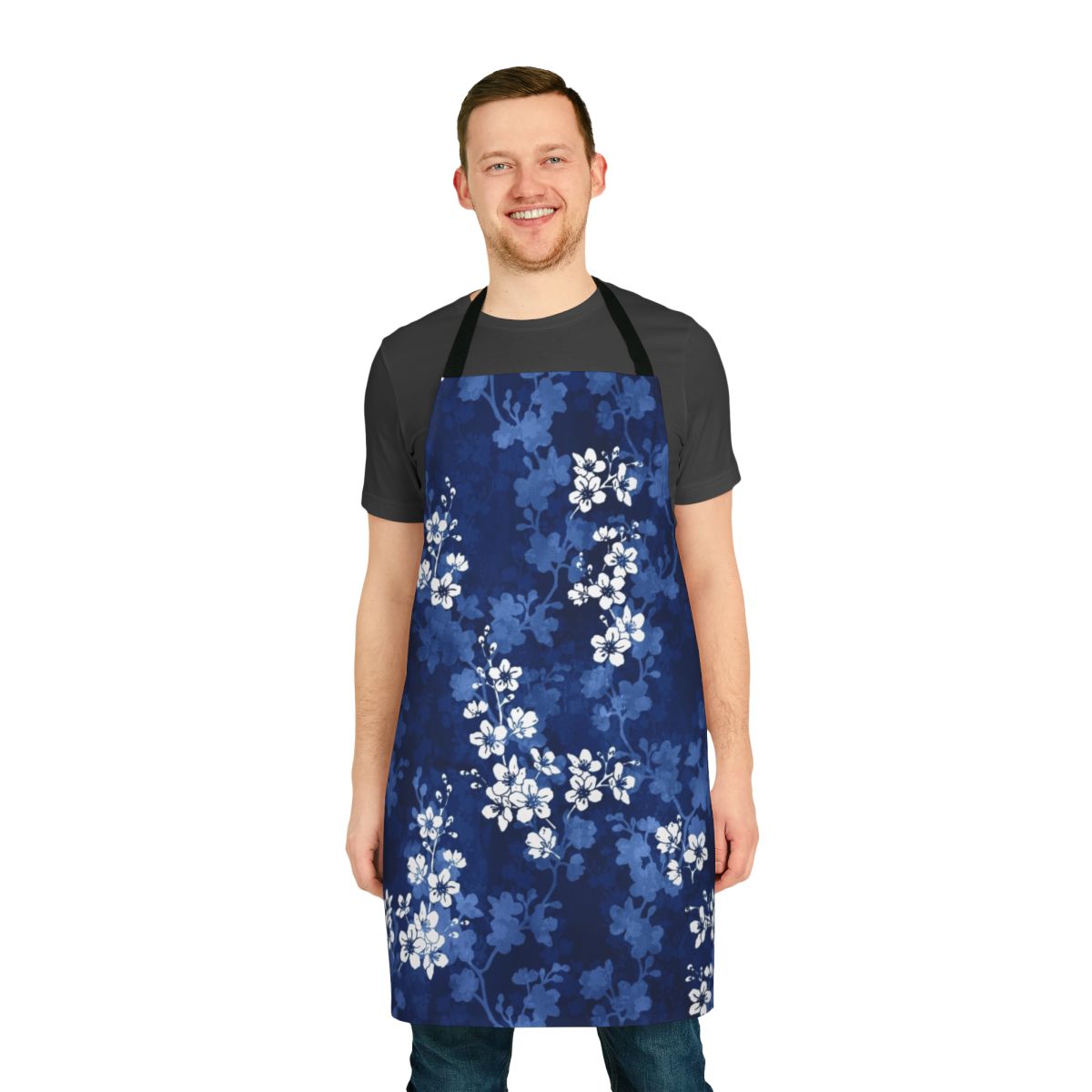 An apron featuring a watercolor pattern of sakura blossoms and swallowtail butterflies in shades of blue.