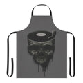 A dark and surreal apron featuring a skull and dancing figure design