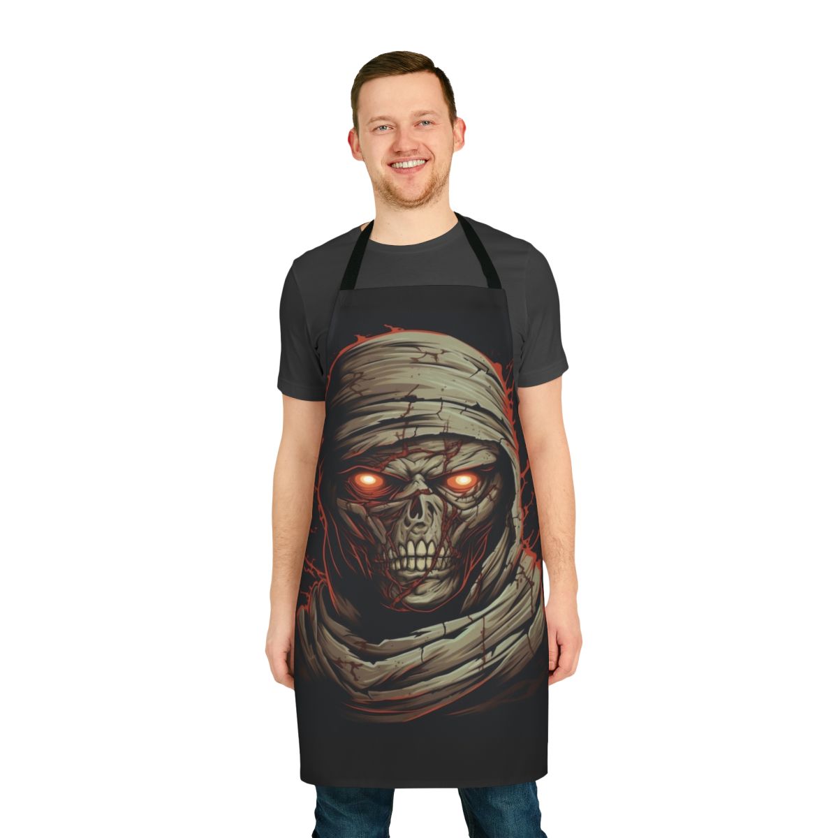 A dark, sinister-looking apron with a mummy design, featuring cracked pale skin, glowing red eyes, and sharp decayed teeth.