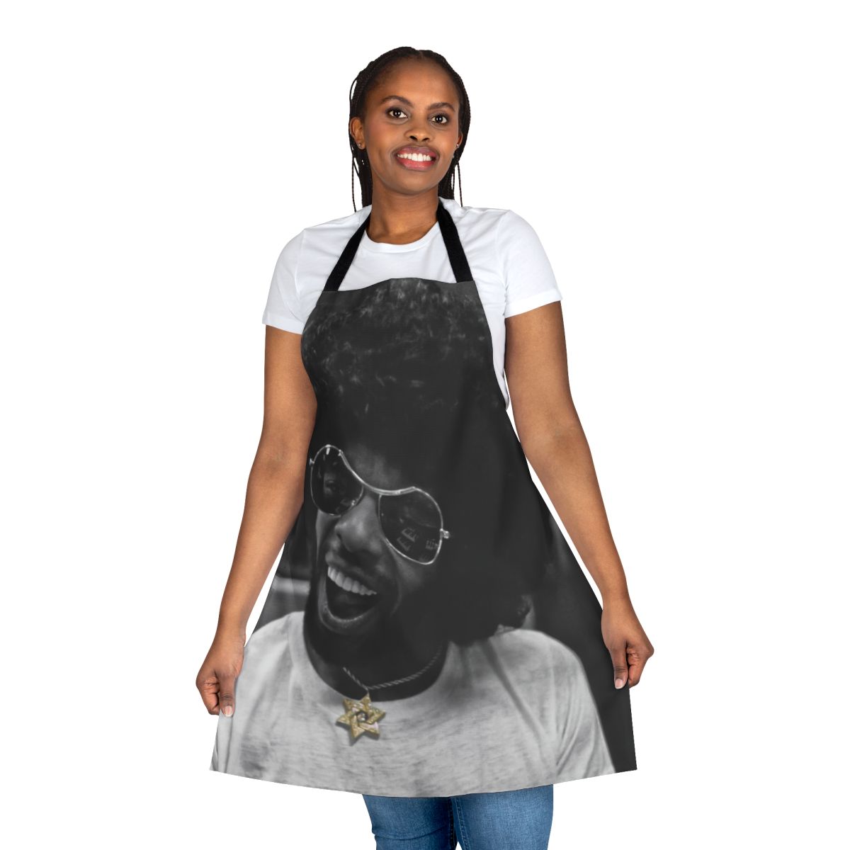 Black and white photo of a musician wearing a kitchen apron with a star of David and gold and diamond accents, in a recording studio.