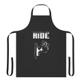 A person wearing a snowboarding-themed apron while cooking or crafting in a winter setting.