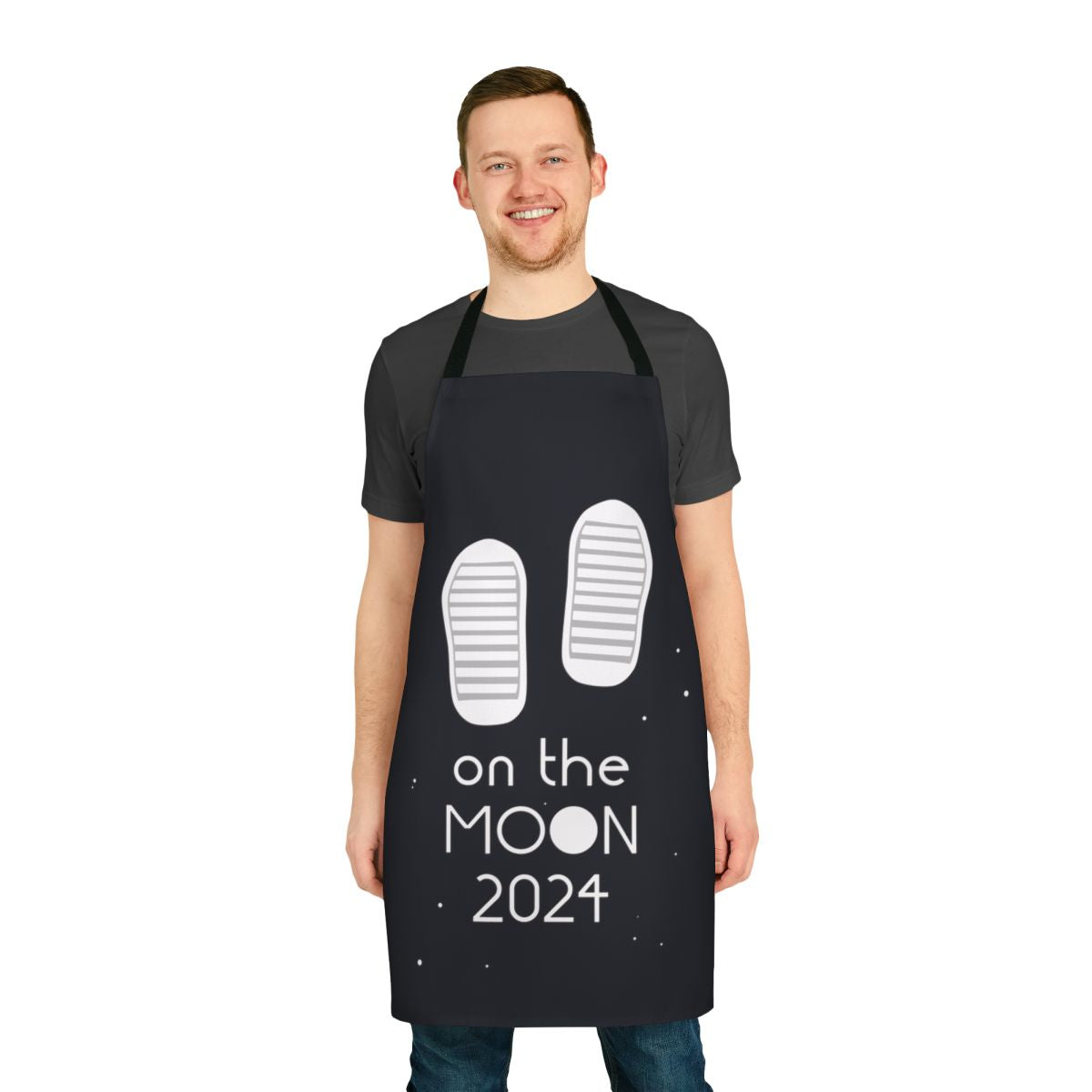 A white apron with the text 'Boots On The Moon 2024' and a moon graphic, referencing the popular space force tv show.