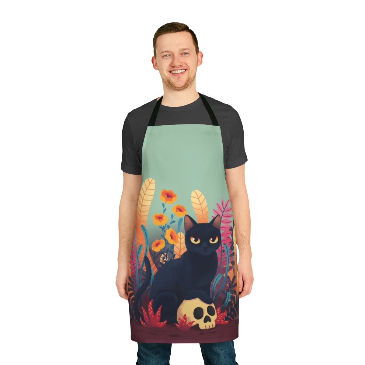 An apron featuring a cute and spooky skull cat design with floral and autumn elements.