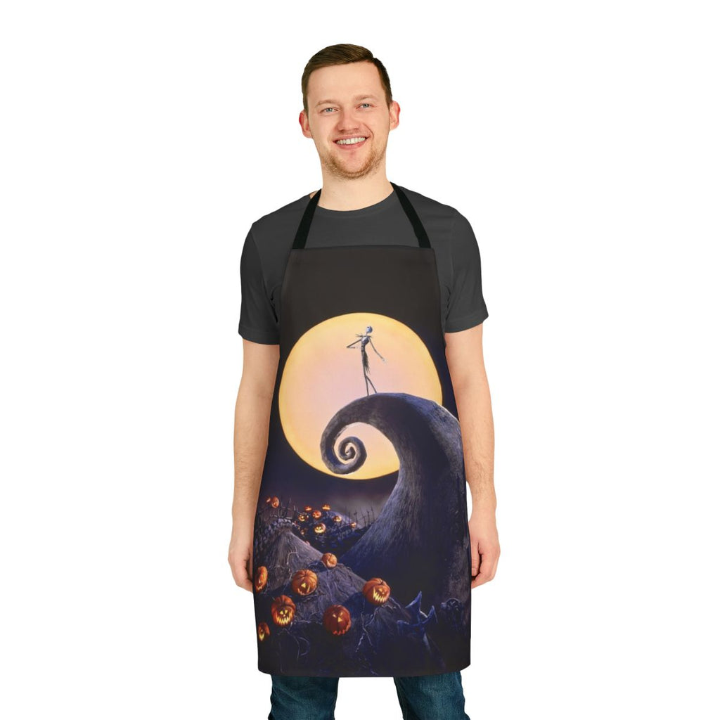 A black apron with a pumpkin skull design, inspired by the classic Tim Burton film The Nightmare Before Christmas.