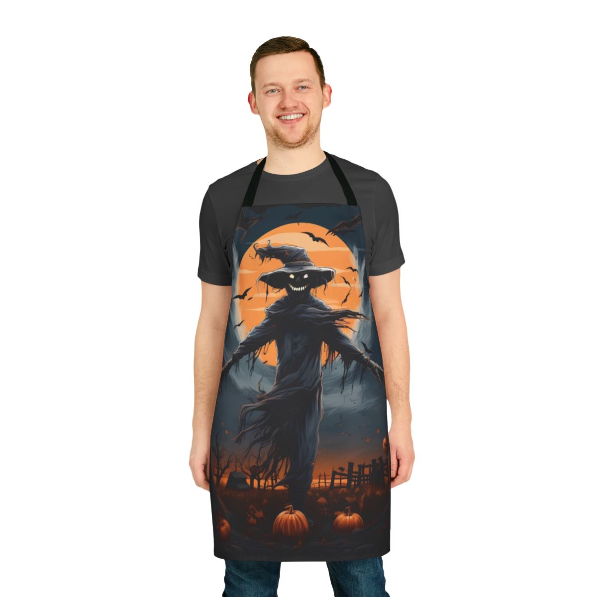 Haunting scarecrow design on a black apron under a full moon