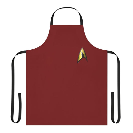 A black and gold apron featuring the iconic Starfleet silhouette, perfect for Star Trek fans who love their feline companions.