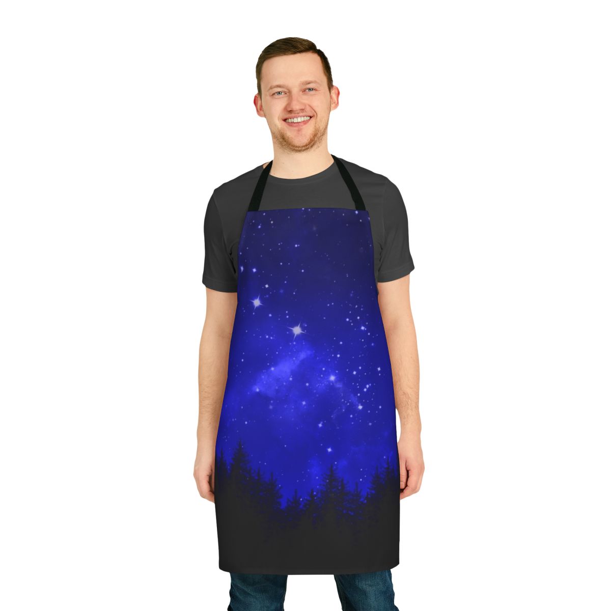 Apron featuring a blue galaxy forest night sky design with silhouettes of trees, mountains, and the moon.