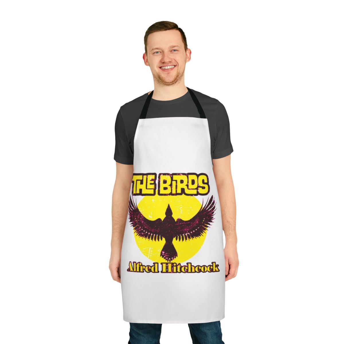 An apron featuring a stylized portrait of Alfred Hitchcock, the legendary film director, and a nod to his classic horror movie "The Birds".
