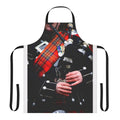 A red tartan apron with a bagpipe design, perfect for enjoying traditional Scottish music and culture.