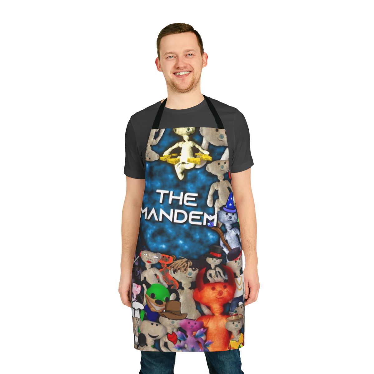 A man wearing a playful bear-themed apron while cooking or grilling