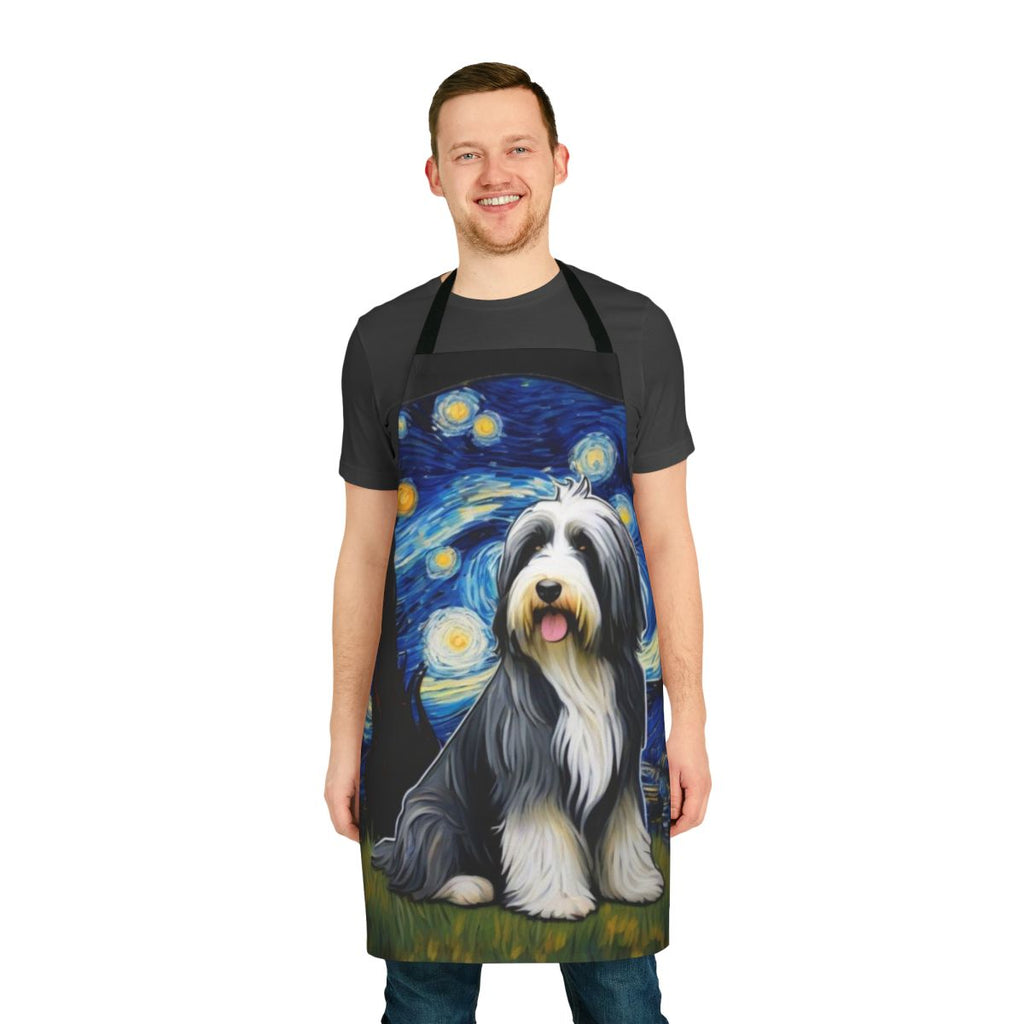 Bearded collie dog wearing a blue apron with a starry night pattern