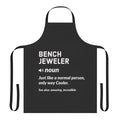 Bench jeweler wearing a stylish apron with jewelry tools and accessories