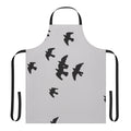 Stylish black apron featuring a design with birds, animals, and nature imagery