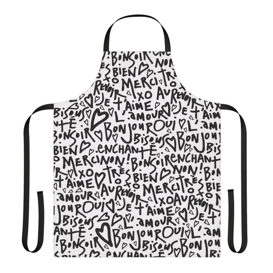 A white apron with a black hand-drawn design featuring the French phrase "I love you" and other French words and phrases.