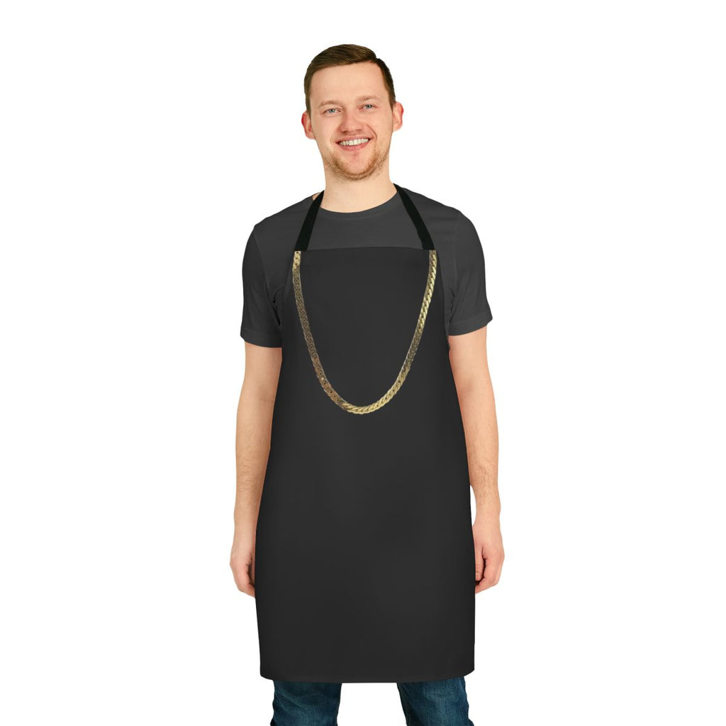 Model wearing a gold chain apron in the kitchen