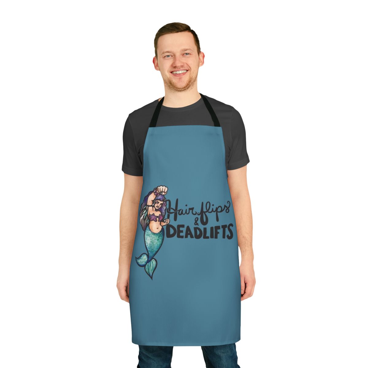 A black apron with the text "Hair Flips and Deadlifts" and a mermaid graphic, perfect for weightlifting and fitness fans.