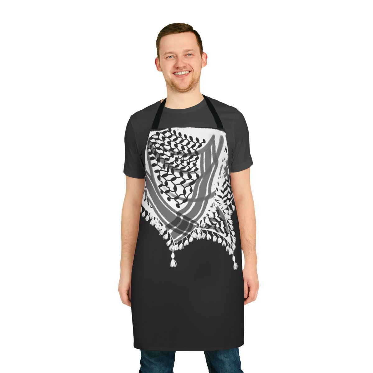 Apron featuring a keffiyeh-style neck scarf illustration in black and white with waves and tassels.