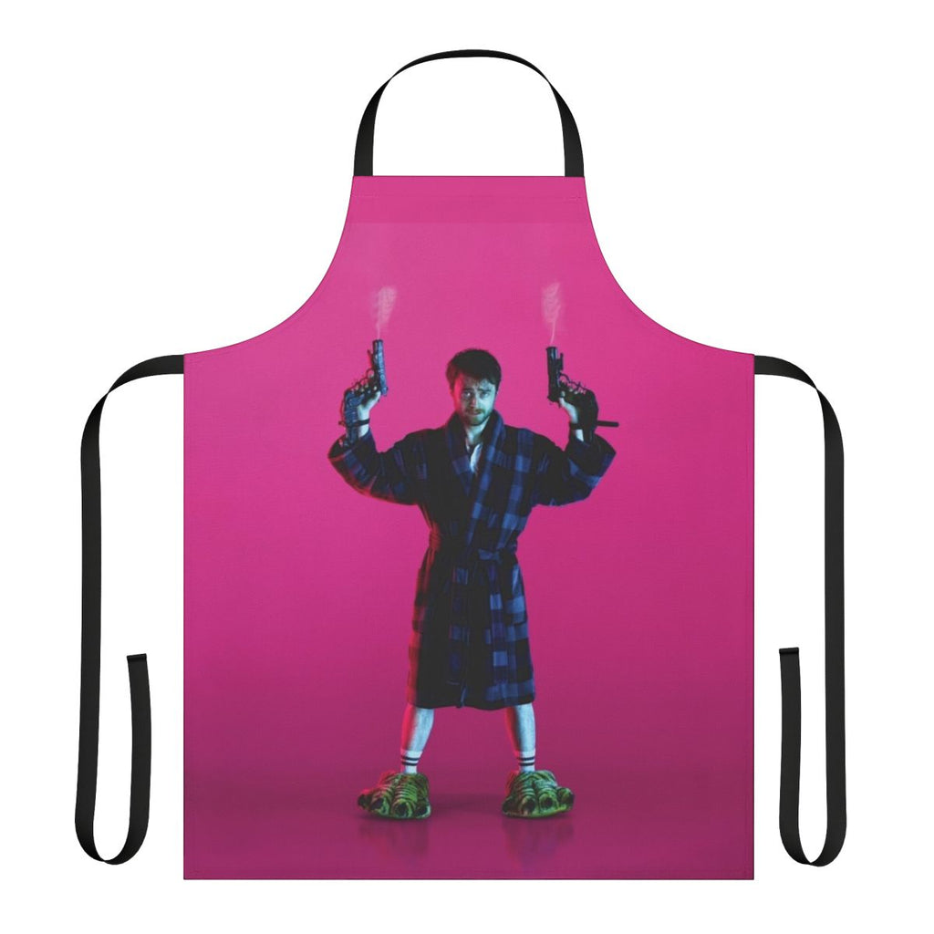 Pink apron with the text "Guns Akimbo" and a gun graphic, inspired by the movie starring Daniel Radcliffe.