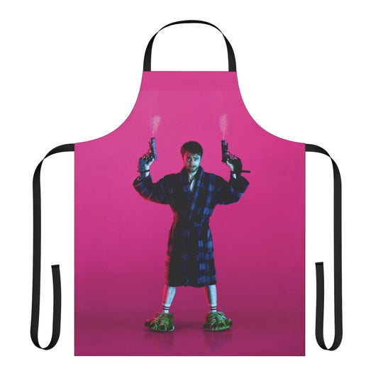 Pink apron with the text "Guns Akimbo" and a gun graphic, inspired by the movie starring Daniel Radcliffe.