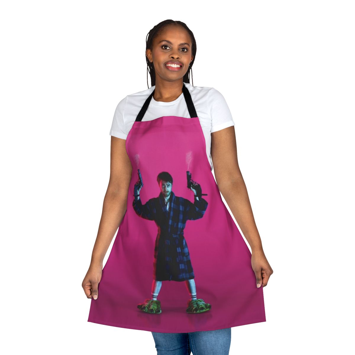 Pink apron with the text "Guns Akimbo" and a gun graphic, inspired by the movie starring Daniel Radcliffe.
