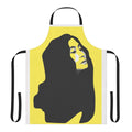 A vibrant yellow apron featuring a stenciled portrait of musician Yoko Ono.