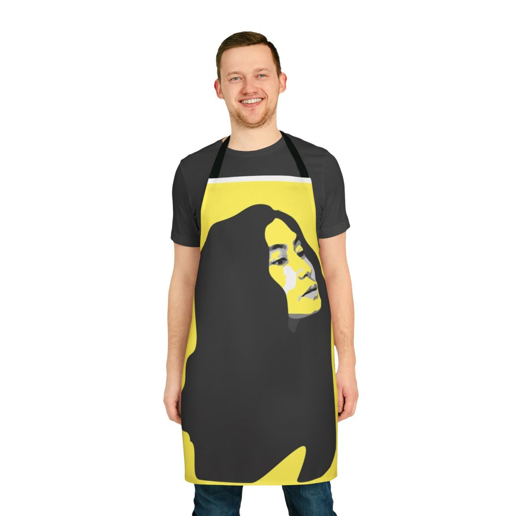 A vibrant yellow apron featuring a stenciled portrait of musician Yoko Ono.