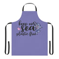 Narwhal-patterned apron in shades of blue, promoting a plastic-free ocean