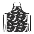 Black and white apron with a seamless repeating pattern of whales, including whale tails, flippers, and other oceanic details.