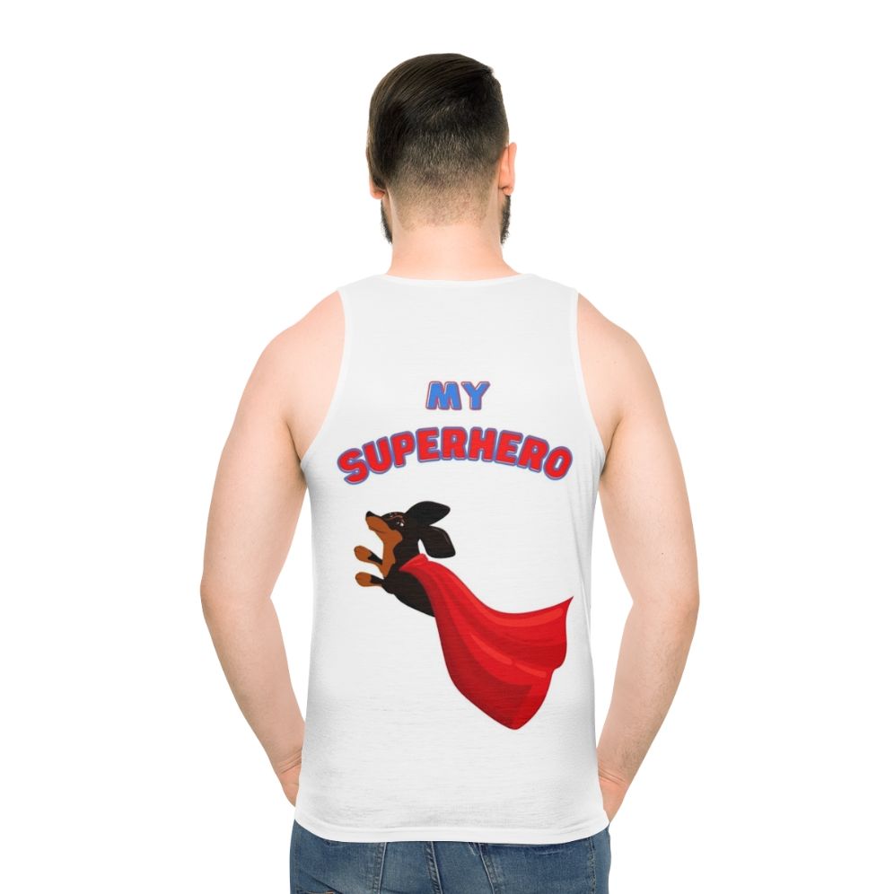 Superhero dachshund wearing a black tank top