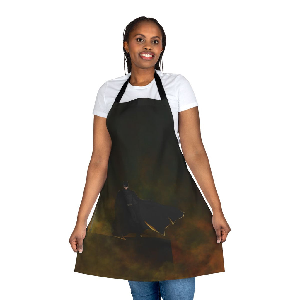 A colorful superhero-themed apron with images of bats and comic book elements