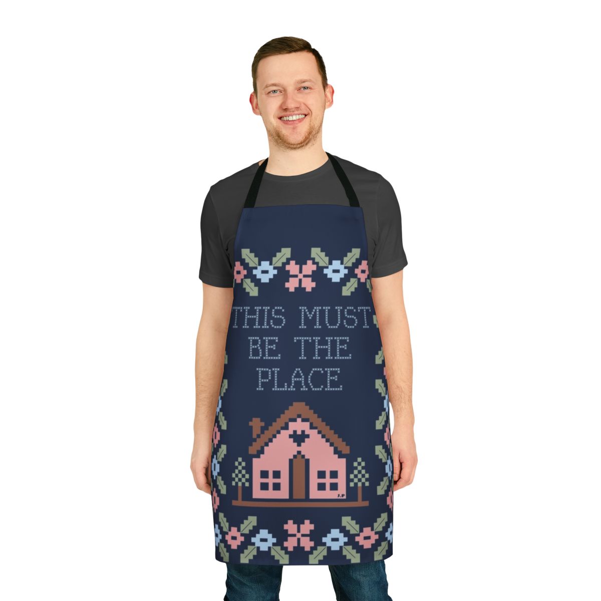 A stylish and high-quality kitchen apron featuring a graphic design inspired by the iconic Talking Heads song "This Must Be the Place".