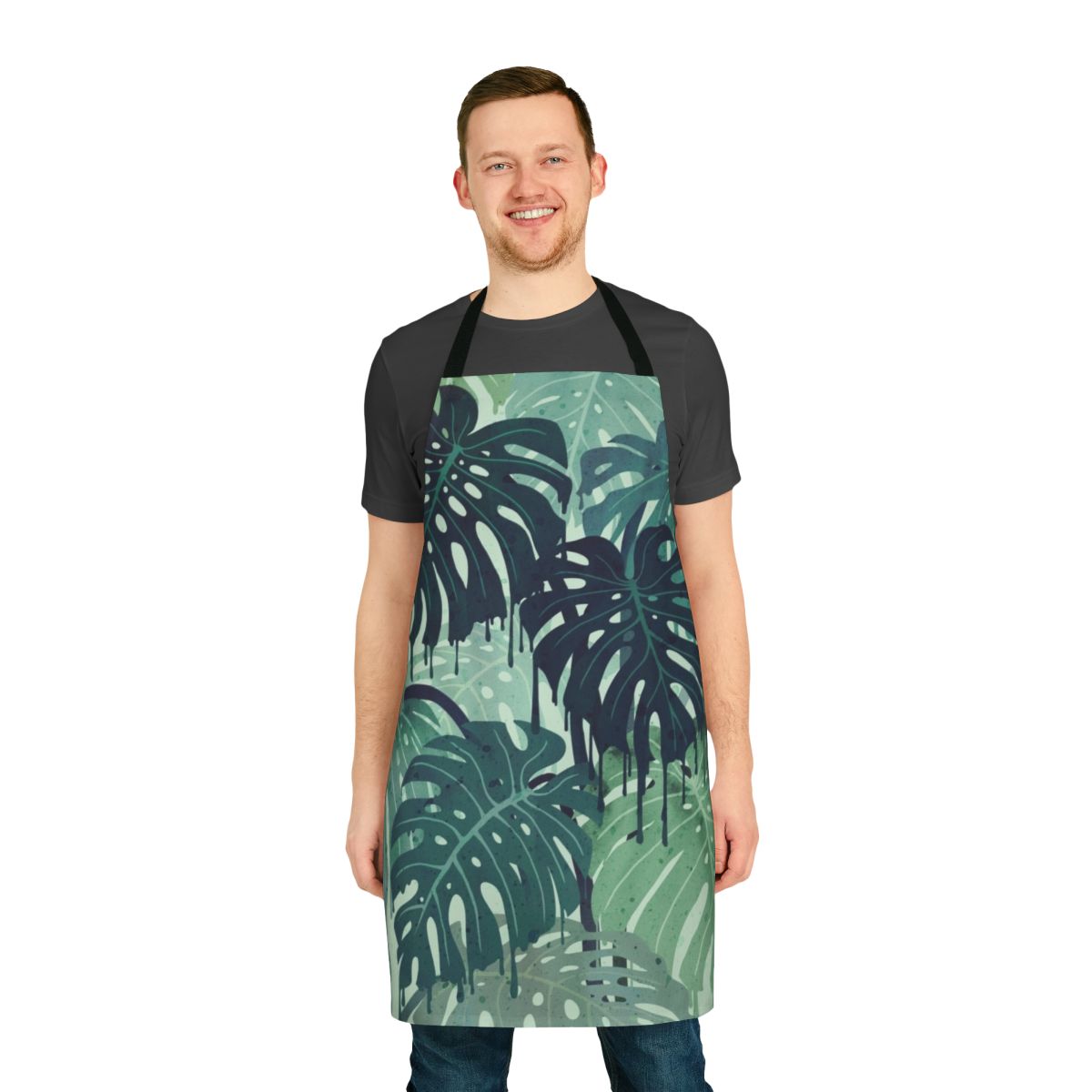 Tropical monstera leaves pattern on a green apron with blue accents