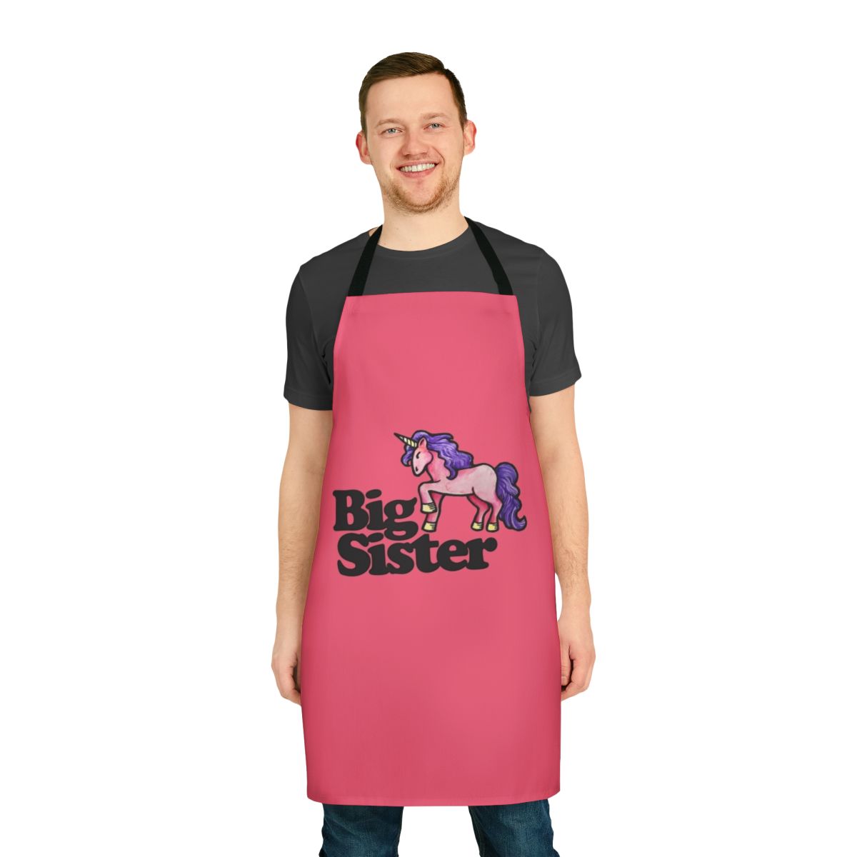 Big sister holding a unicorn apron, a special and personalized gift