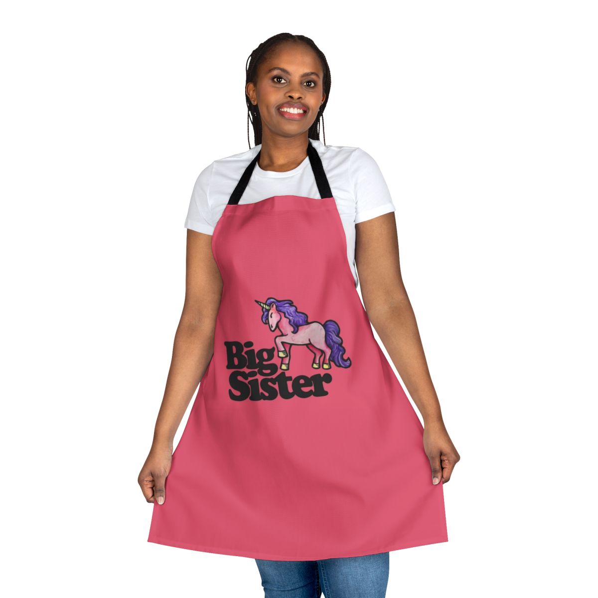 Big sister holding a unicorn apron, a special and personalized gift